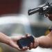 Inseguridad-crece-en-nl - Tu Vecino Informa a Street Robbery Scene with a Person Handing over a Smartphone While Another Person Points a Revolver at Them. - Tu Vecino Informa
