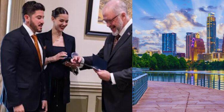 Three Professionals in Suits Exchange an Award Indoors, Smiling Near a Framed Picture on the Wall (left Side). the Right Side Shows a Modern City Skyline by a River with a Wooden Boardwalk. - Tu Vecino Informa