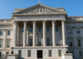 Front View of a Neoclassical Government Building with a Row of Tall Columns, a Sculpted Pediment, and a Blue Sky Above. - Tu Vecino Informa